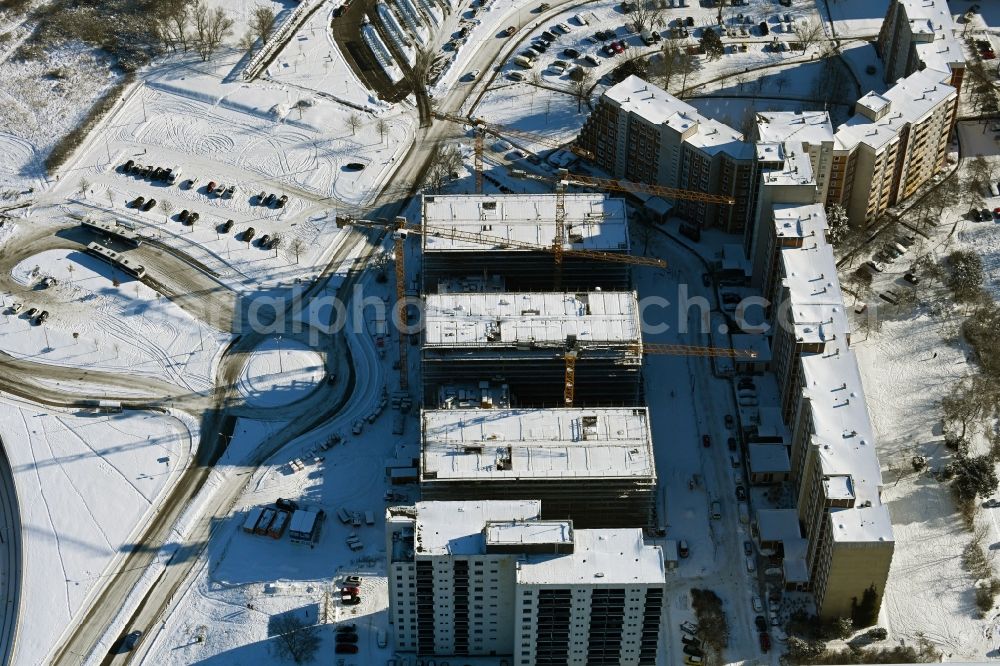 Rostock from above - Wintry snowy construction site to build a new office and commercial building on Bahnhofsvorplatz in the district Suedstadt in Rostock in the state Mecklenburg - Western Pomerania, Germany