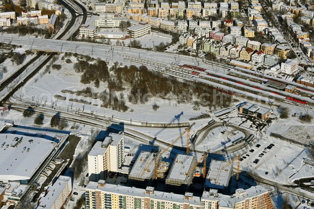 Rostock from above - Wintry snowy construction site to build a new office and commercial building on Bahnhofsvorplatz in the district Suedstadt in Rostock in the state Mecklenburg - Western Pomerania, Germany