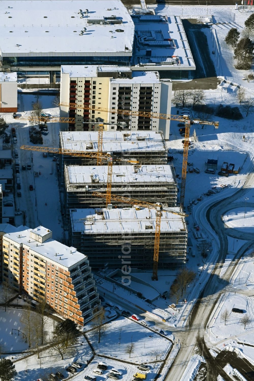 Rostock from above - Wintry snowy construction site to build a new office and commercial building on Bahnhofsvorplatz in the district Suedstadt in Rostock in the state Mecklenburg - Western Pomerania, Germany