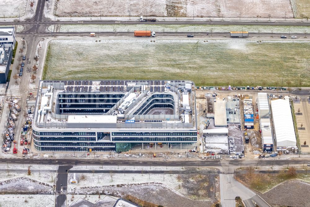 Dortmund from above - Wintry snowy construction site to build a new office and commercial building on Robert-Schuman-Strasse in the district Phoenix West in Dortmund at Ruhrgebiet in the state North Rhine-Westphalia, Germany