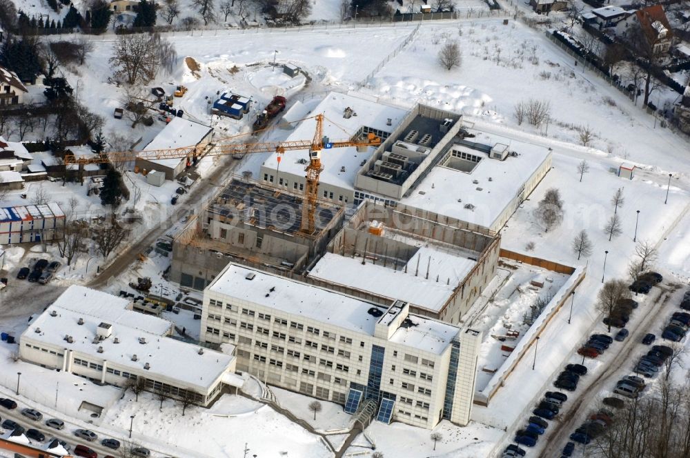 Berlin from above - Wintry snowy building complex and grounds of the logistics center - data center of DB Systel GmbH on Florastrasse in the district Mahlsdorf in Berlin, Germany