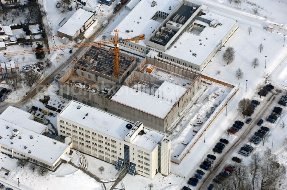 Aerial image Berlin - Wintry snowy building complex and grounds of the logistics center - data center of DB Systel GmbH on Florastrasse in the district Mahlsdorf in Berlin, Germany