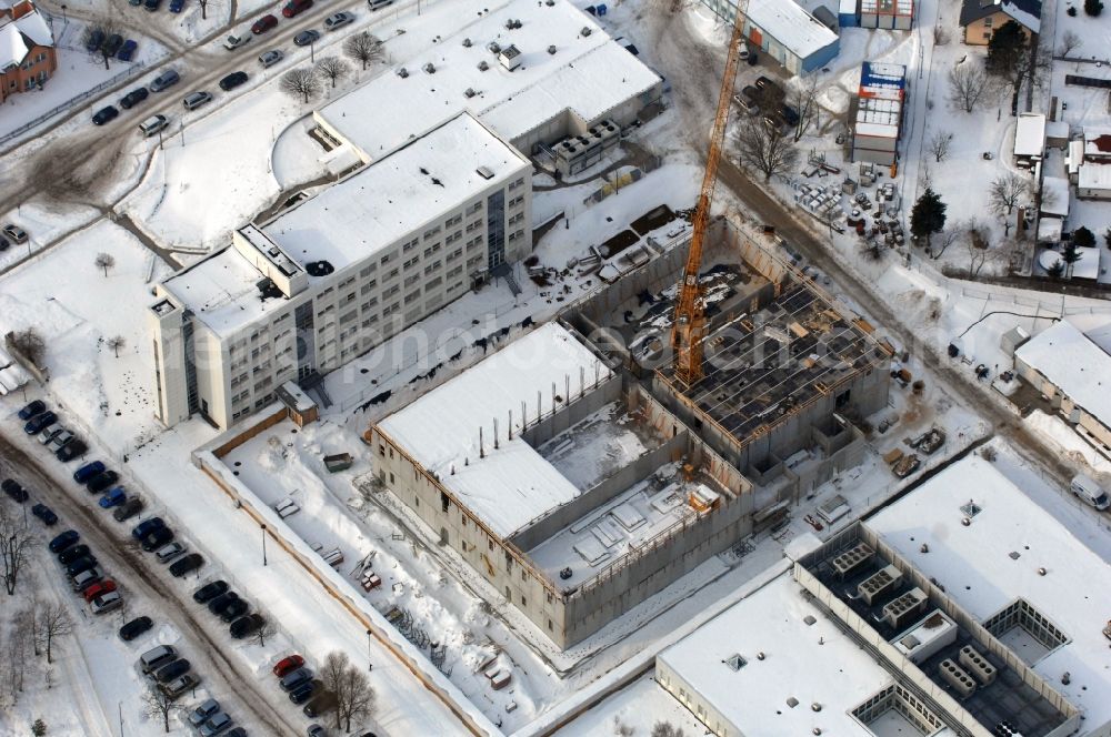 Berlin from above - Wintry snowy building complex and grounds of the logistics center - data center of DB Systel GmbH on Florastrasse in the district Mahlsdorf in Berlin, Germany