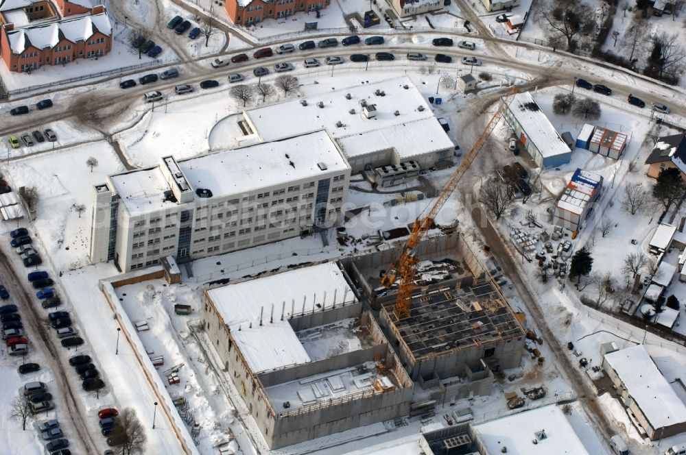 Berlin from the bird's eye view: Wintry snowy building complex and grounds of the logistics center - data center of DB Systel GmbH on Florastrasse in the district Mahlsdorf in Berlin, Germany