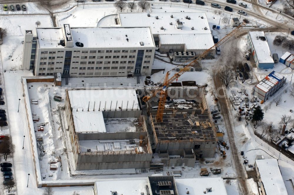 Aerial image Berlin - Wintry snowy building complex and grounds of the logistics center - data center of DB Systel GmbH on Florastrasse in the district Mahlsdorf in Berlin, Germany