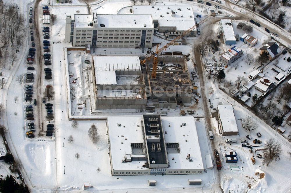 Aerial photograph Berlin - Wintry snowy building complex and grounds of the logistics center - data center of DB Systel GmbH on Florastrasse in the district Mahlsdorf in Berlin, Germany