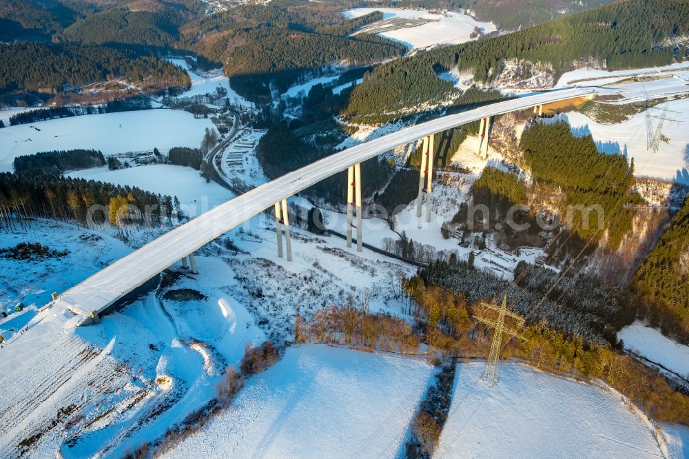 Aerial image Bestwig - Wintry snowy viaduct Nuttlar under construction overlooking the municipality Bestwig in North Rhine-Westphalia