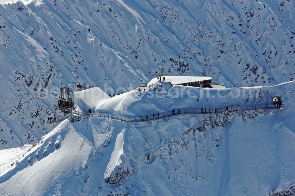 Aerial photograph Oberstdorf - Wintry snowy The newly opened peak station of the Nebelhornbahn in Oberstdorf in the state of Bavaria. The summit restaurant was designed by architect Hermann Kaufmann. Guests can walk around the summit via the Nordwandsteig