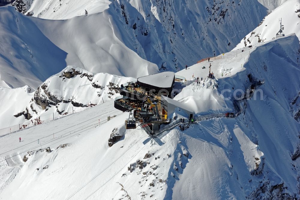 Aerial image Oberstdorf - Wintry snowy newly opened peak station of the Nebelhornbahn in Oberstdorf in the state of Bavaria. The summit restaurant was designed by architect Hermann Kaufmann. Guests can walk around the summit via the Nordwandsteig