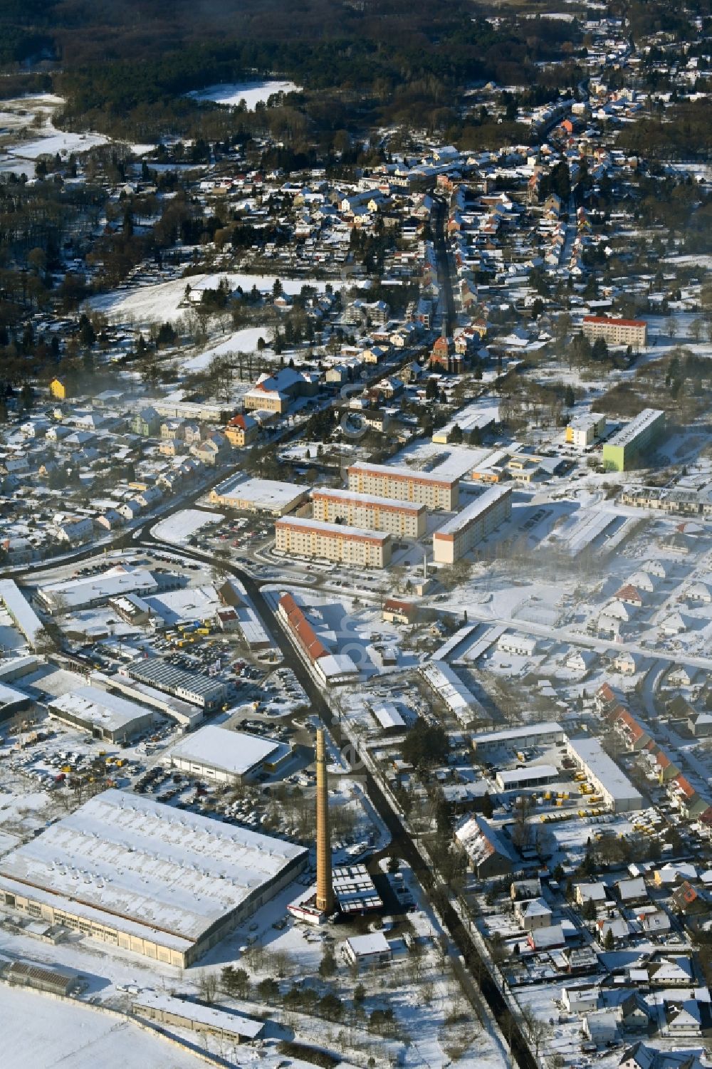 Biesenthal from the bird's eye view: Wintry snowy town View of the streets and houses of the residential areas in Biesenthal in the state Brandenburg, Germany