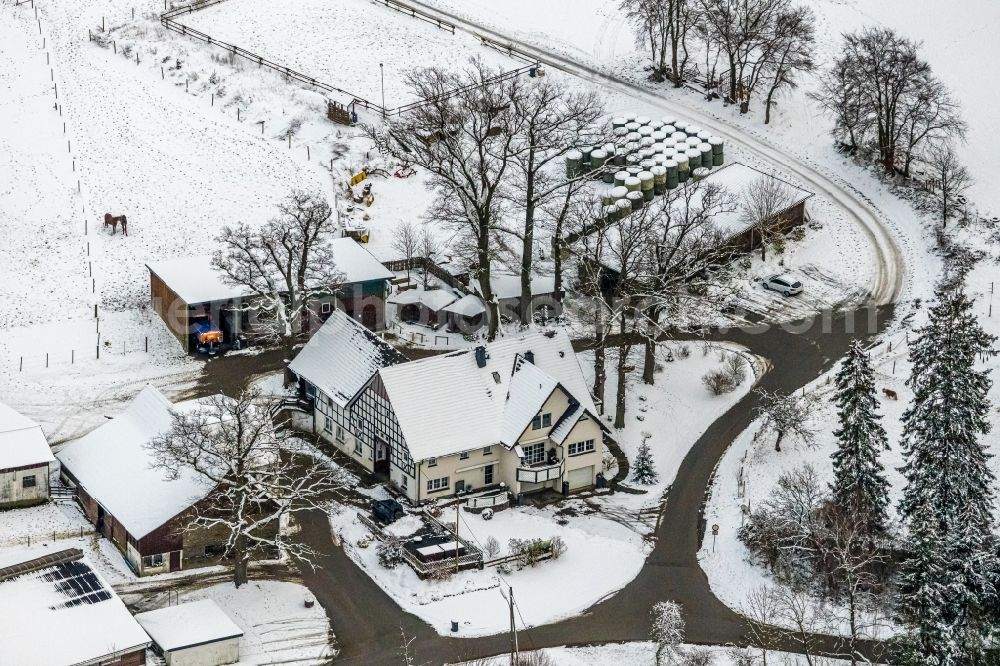 Mosebolle from the bird's eye view: Wintry snowy streets and houses and residential areas in Mosebolle at Sauerland in the state North Rhine-Westphalia, Germany