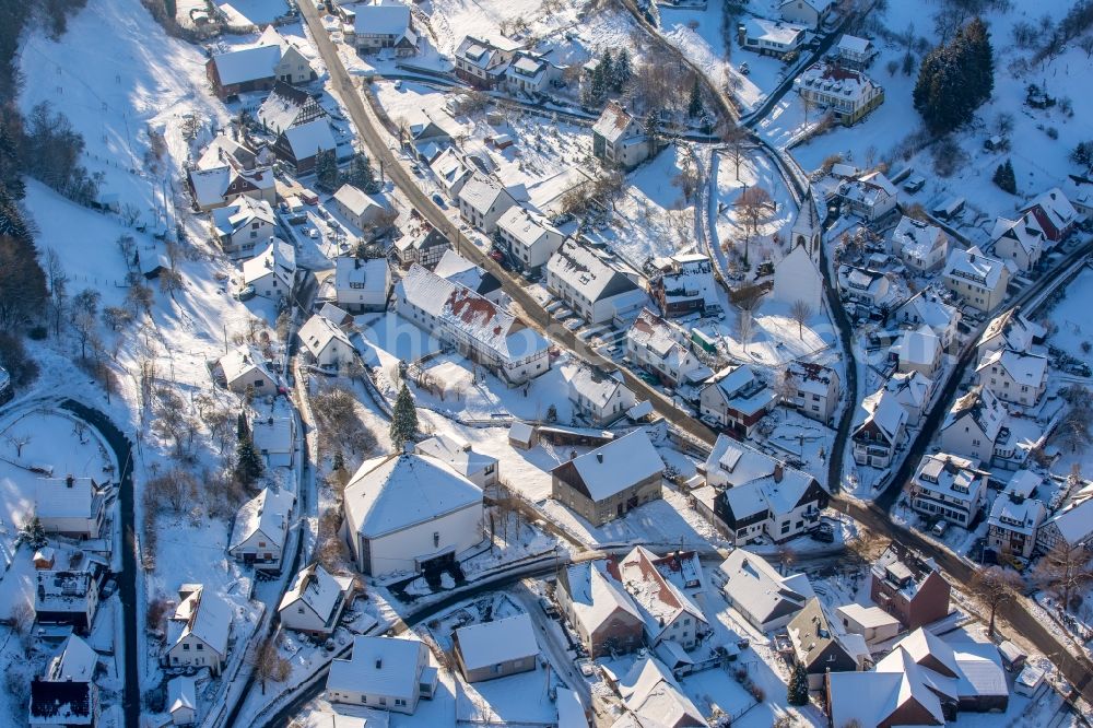 Aerial image Brilon - Wintry snowy Town View of the streets and houses of the residential areas in the district Messinghausen in Brilon in the state North Rhine-Westphalia