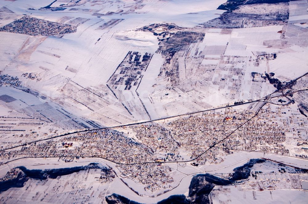 Aerial image Budesti - Wintry snowy village view on the edge of agricultural fields and land in Budesti in Chisinau, Moldawien