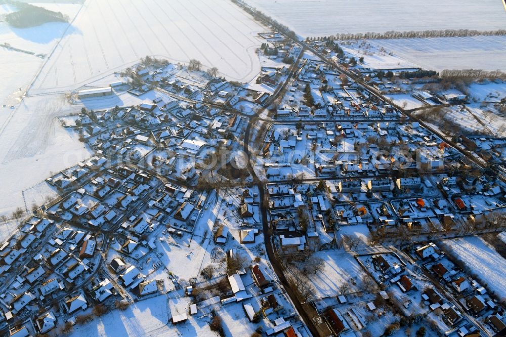 Lübesse from above - Wintry snowy village view on the edge of agricultural fields and land in Luebesse in the state Mecklenburg - Western Pomerania, Germany