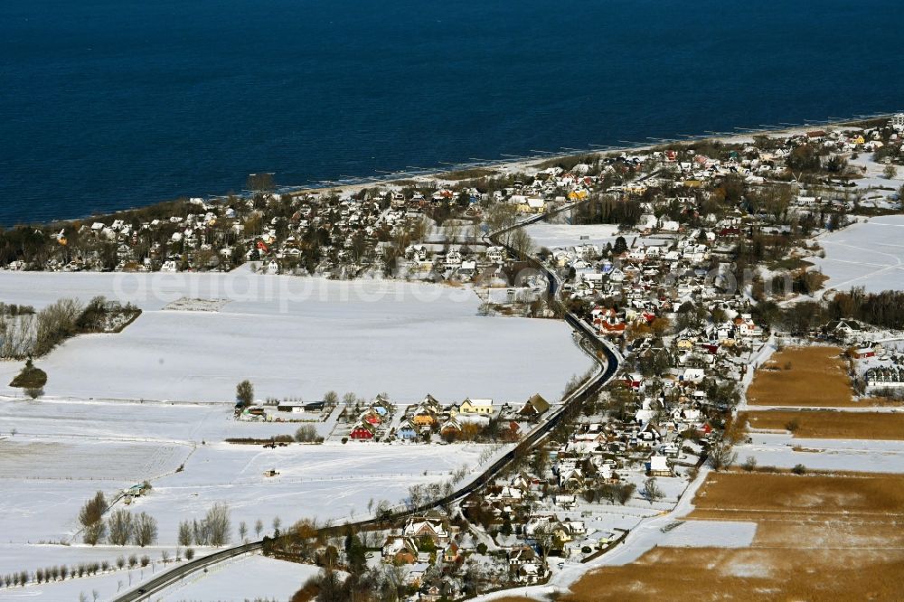 Niehagen from the bird's eye view: Wintry snowy village view on the edge of agricultural fields and land in the district Althagen in Niehagen in the state Mecklenburg - Western Pomerania, Germany