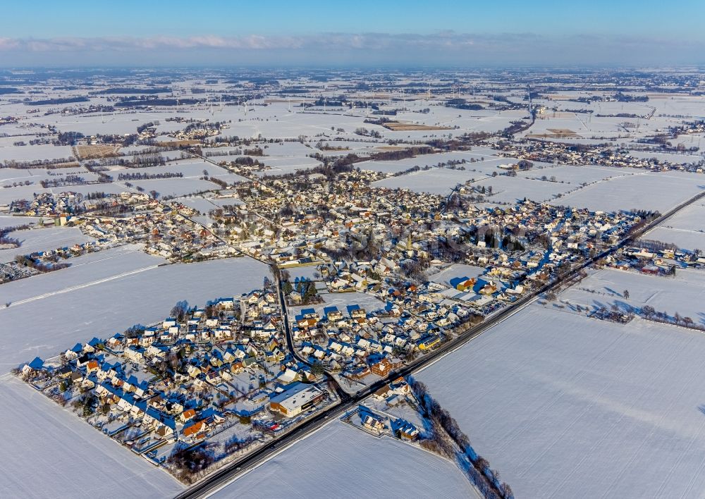 Westönnen from above - Wintry snowy village view on the edge of agricultural fields and land in Westoennen in the state North Rhine-Westphalia, Germany