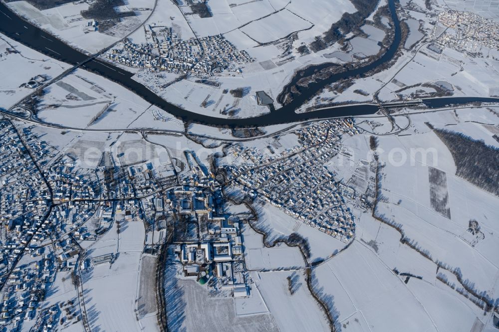 Schwarzach am Main from above - Wintry snowy village on the banks of the area Main - river course in Schwarzach am Main in the state Bavaria, Germany