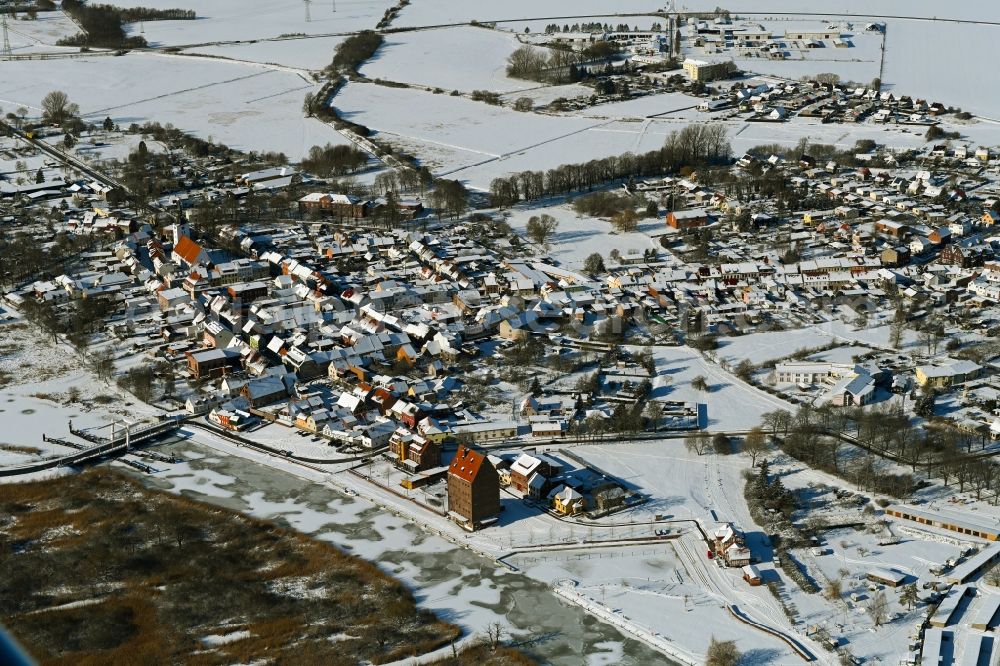 Loitz from above - Wintry snowy village on the banks of the area Peene - river course in Loitz in the state Mecklenburg - Western Pomerania, Germany