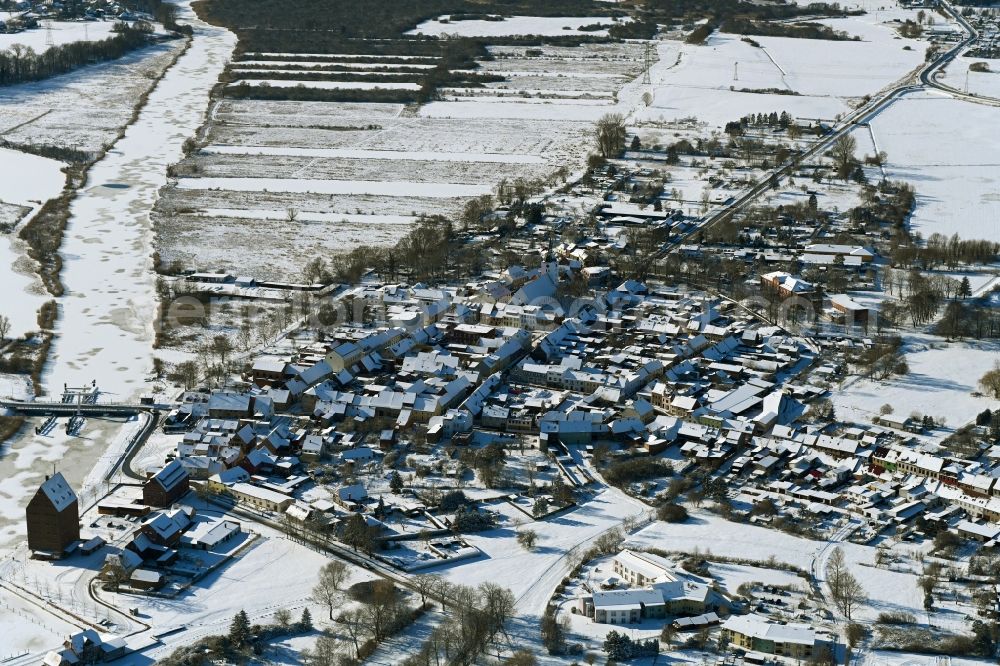 Loitz from the bird's eye view: Wintry snowy village on the banks of the area Peene - river course in Loitz in the state Mecklenburg - Western Pomerania, Germany