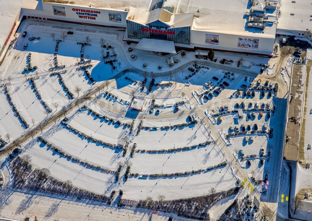 Aerial photograph Witten - Wintry snowy OSTERMANN Einrichtungs-Centrum Witten on Fredi-Ostermann-Strasse with parking and storage space for automobiles in Witten in the state North Rhine-Westphalia