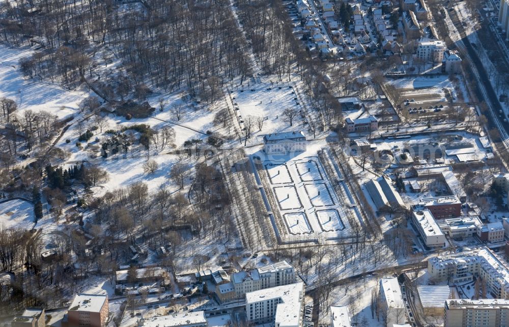 Berlin from the bird's eye view: Wintry snowy night pinky lighting palace Friedrichsfelde Tierpark in the district Friedrichsfelde in Berlin, Germany