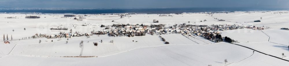 Oberlauterbach from above - Wintry snowy Panoramic perspective Village - view on the edge of agricultural fields and farmland in Oberlauterbach in Grand Est, France