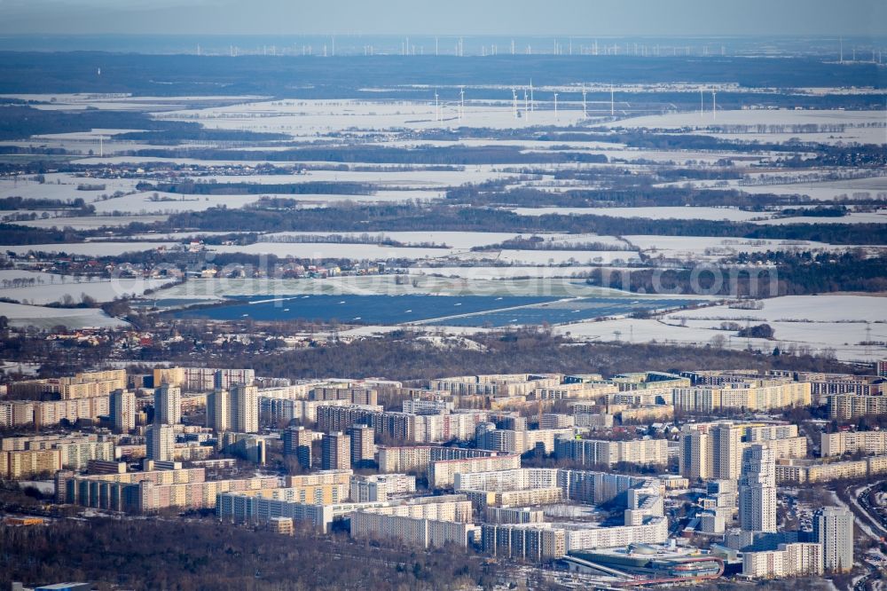 Aerial photograph Berlin - Wintry snowy skyscrapers in the residential area of industrially manufactured settlement along the Maerkischen Allee in the district Marzahn in Berlin, Germany