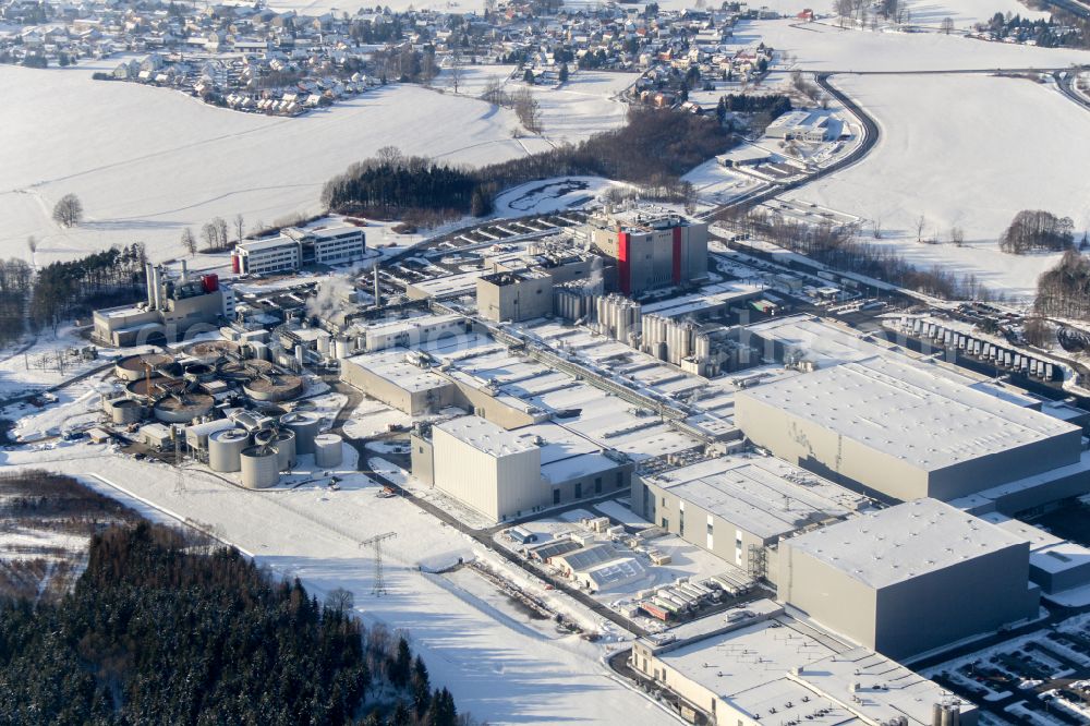 Feldschlößchen from the bird's eye view: Wintry snowy production facilities of the Sachsenmilch company in Leppersdorf in the federal state of Saxony