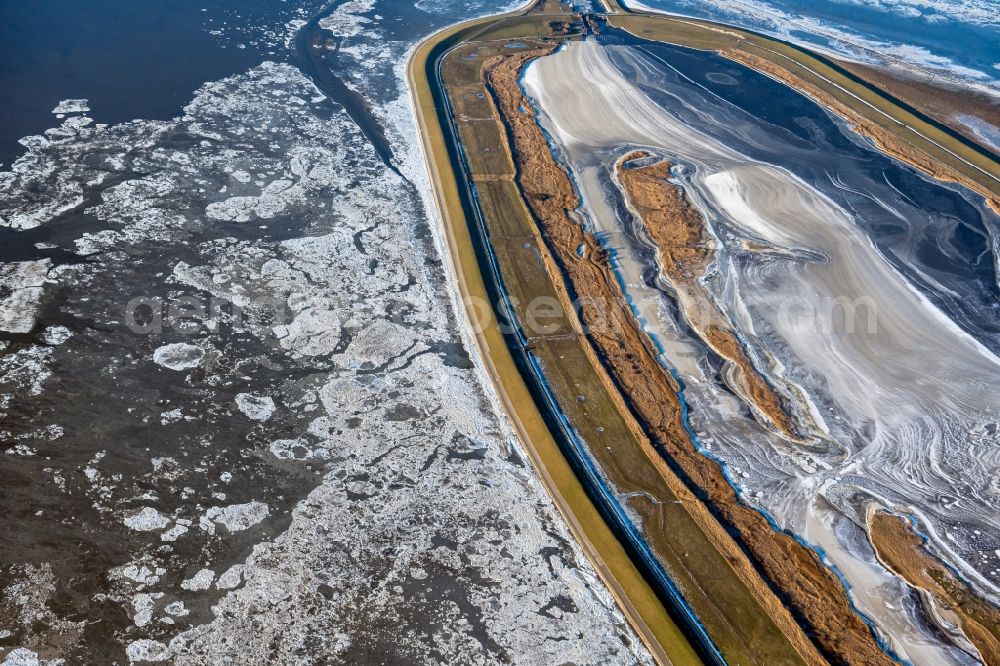 Krummhörn from above - Wintry snowy retention basin and water storage Leyhoern in Krummhoern in the state Lower Saxony, Germany