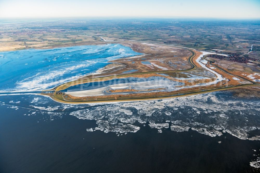 Krummhörn from the bird's eye view: Wintry snowy retention basin and water storage Leyhoern in Krummhoern in the state Lower Saxony, Germany