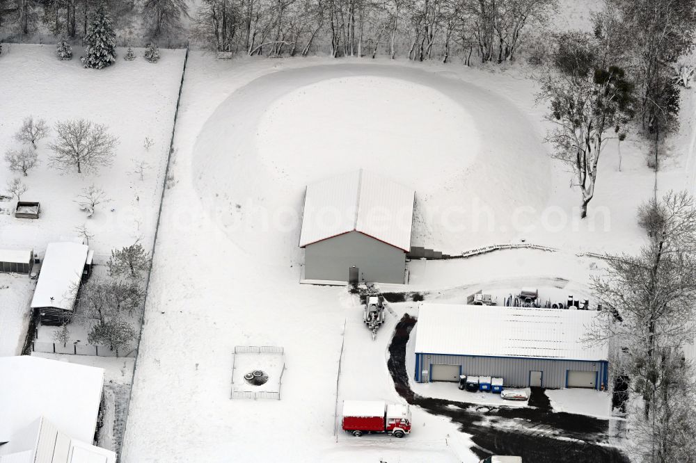 Aerial image Werneuchen - Wintry snowy construction site for the new construction of the retention basin and water storage on street Wesendahler Strasse in Werneuchen in the state Brandenburg, Germany