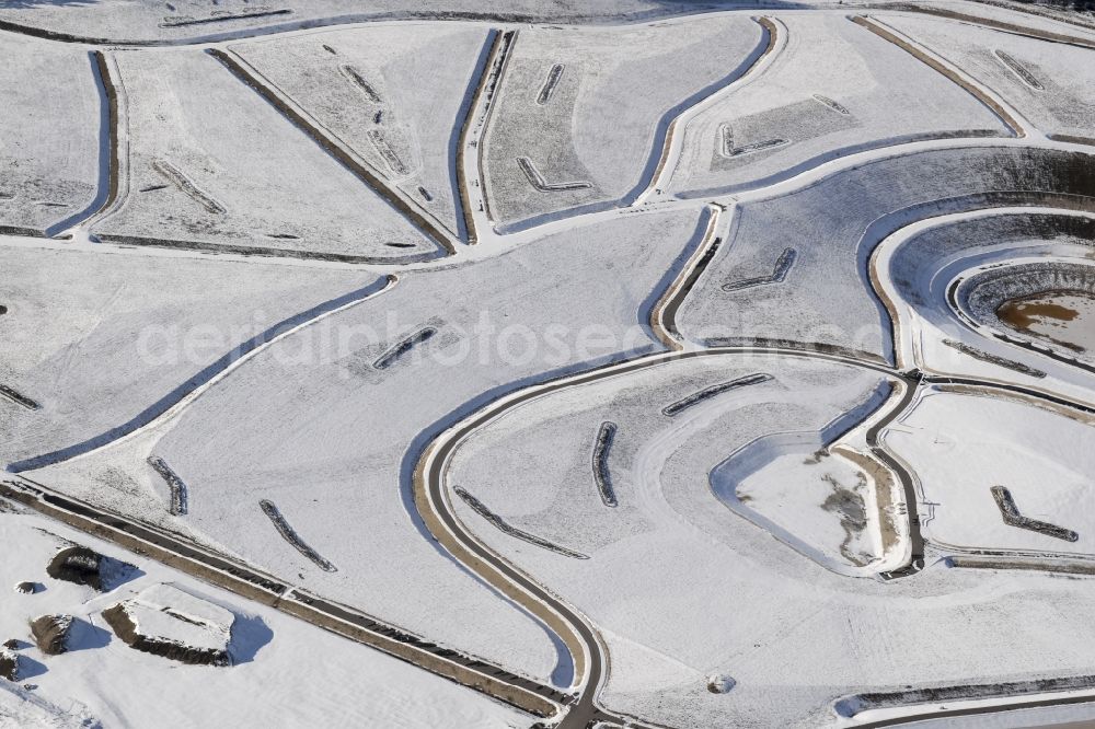 Wackersdorf from the bird's eye view: Wintry snowy rehabilitation and renaturation work on the layers of a mining waste dump in Wackersdorf in the state Bavaria, Germany