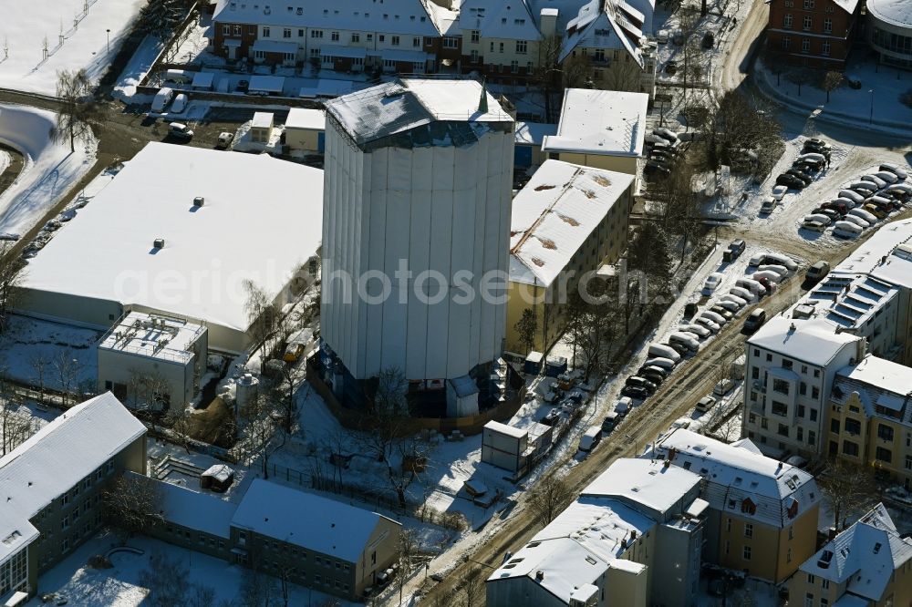 Rostock from above - Wintry snowy construction site Tourist attraction of the historic monument of Wasserturm on Bluecherstrasse in Rostock in the state Mecklenburg - Western Pomerania, Germany