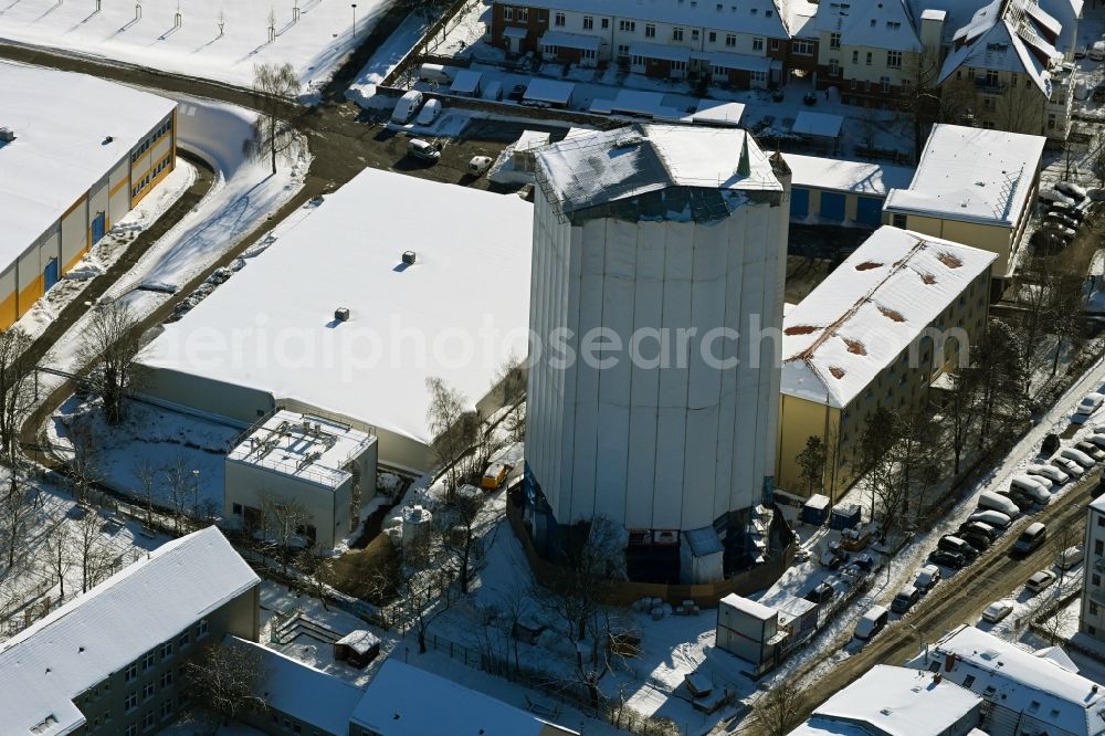 Rostock from the bird's eye view: Wintry snowy construction site Tourist attraction of the historic monument of Wasserturm on Bluecherstrasse in Rostock in the state Mecklenburg - Western Pomerania, Germany