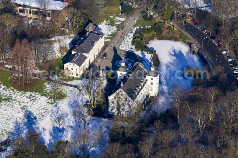 Essen from the bird's eye view: Wintry snowy building complex in the park of the castle on street Schlossstrasse in the district Borbeck in Essen at Ruhrgebiet in the state North Rhine-Westphalia, Germany