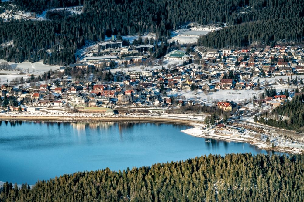 Aerial image Schluchsee - Wintry snowy waterfront landscape on the lake halb zu gefroren in Schluchsee in the state Baden-Wurttemberg, Germany