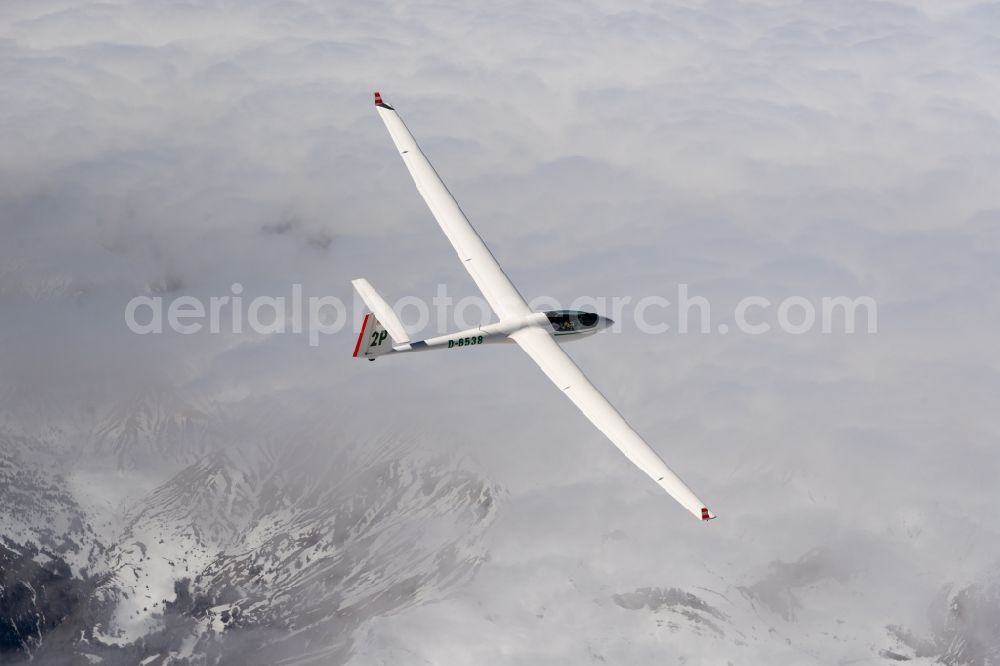 Le Dévoluy from above - Glider ASW 20 D-6538 in flight abov ethe clods and the winterly snow-topped mountains near Le Devoluy in Provence-Alpes-Cote d'Azur, France