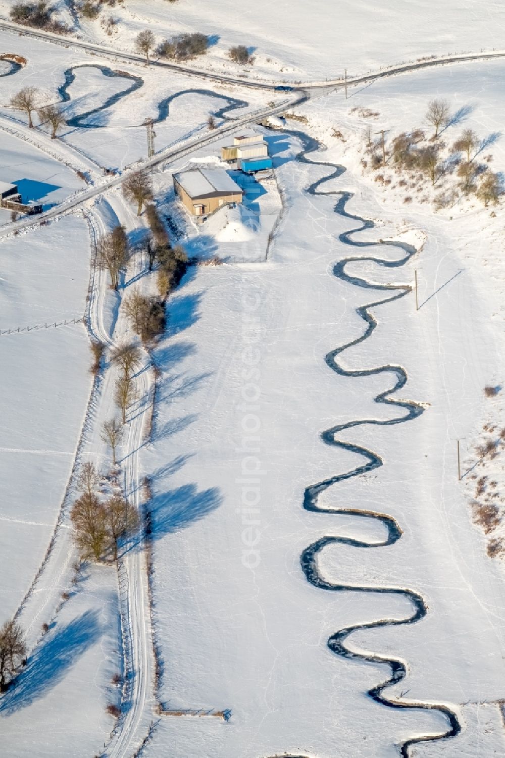 Aerial photograph Brilon - Wintry snowy mean dering, serpentine curve of a river Moehne in Brilon in the state North Rhine-Westphalia