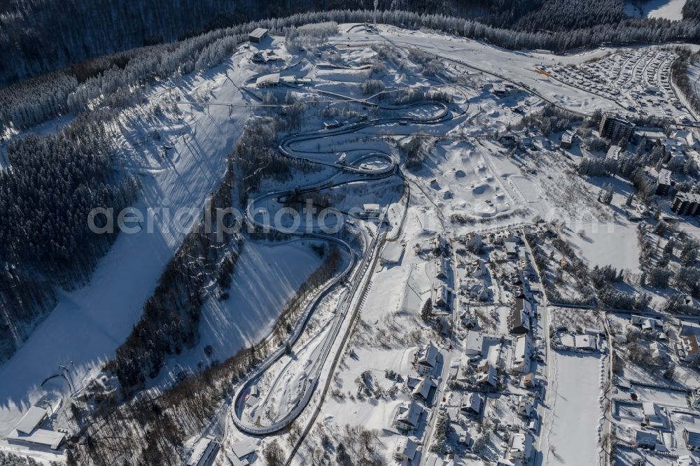 Aerial image Winterberg - Wintry snowy serpentine curve of the racetrack route of Bobbahn Winterberg Hochsauerland in Winterberg in the state North Rhine-Westphalia