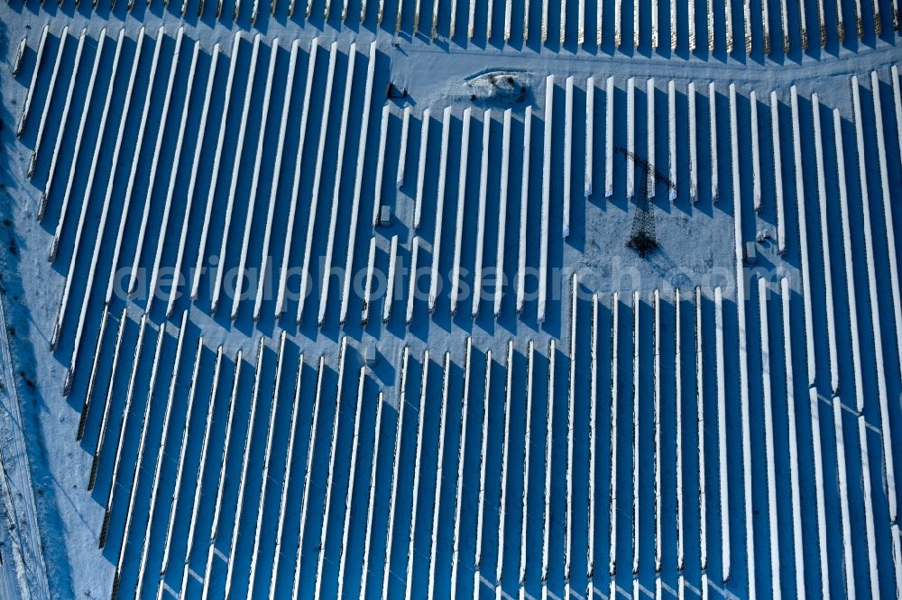 Kelbra (Kyffhäuser) from above - Wintry snowy rows of panels of a solar power plant and photovoltaic system on a on Eichenweg field in the district Thuerungen in Kelbra (Kyffhaeuser) in the state Saxony-Anhalt, Germany