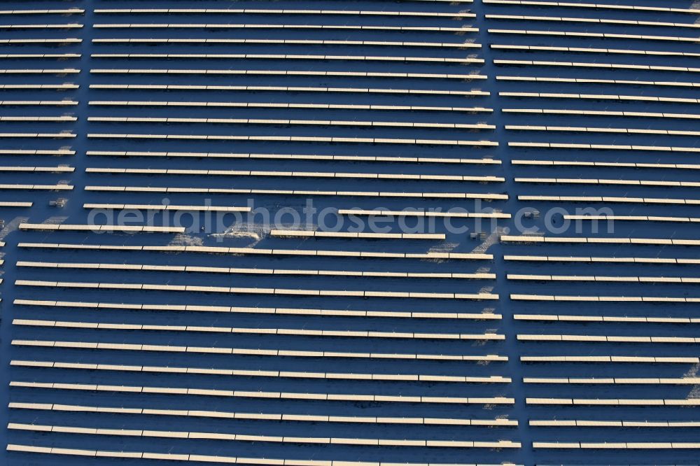 Werneuchen from above - Wintry snowy Panel rows of photovoltaic and solar farm or solar power plant in Werneuchen in the state Brandenburg