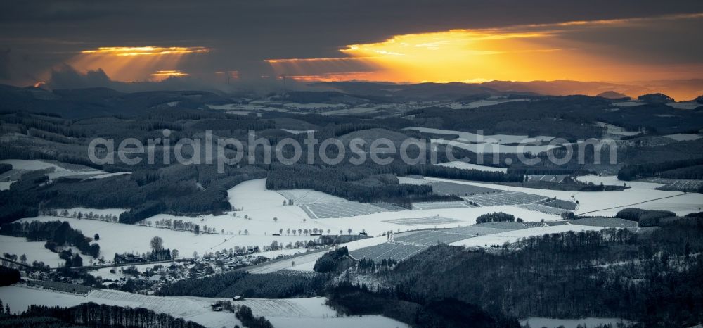 Aerial image Winterberg - Wintry snowy sunset over the countryside on Rothaargebirge in Winterberg in the state North Rhine-Westphalia, Germany