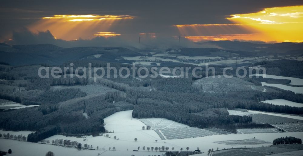 Aerial photograph Winterberg - Wintry snowy sunset over the countryside on Rothaargebirge in Winterberg in the state North Rhine-Westphalia, Germany