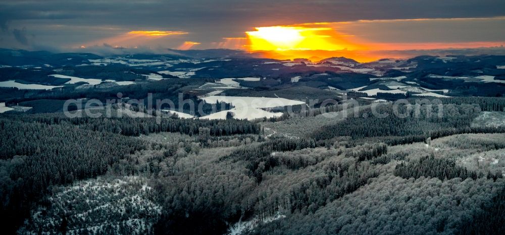 Winterberg from above - Wintry snowy sunset over the countryside on Rothaargebirge in Winterberg in the state North Rhine-Westphalia, Germany