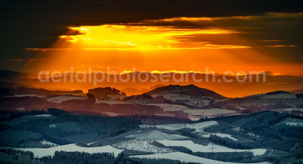 Aerial photograph Winterberg - Wintry snowy sunset over the countryside on Rothaargebirge in Winterberg in the state North Rhine-Westphalia, Germany