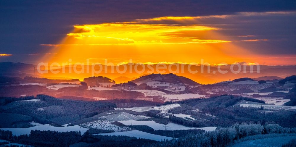 Winterberg from above - Wintry snowy sunset over the countryside on Rothaargebirge in Winterberg in the state North Rhine-Westphalia, Germany