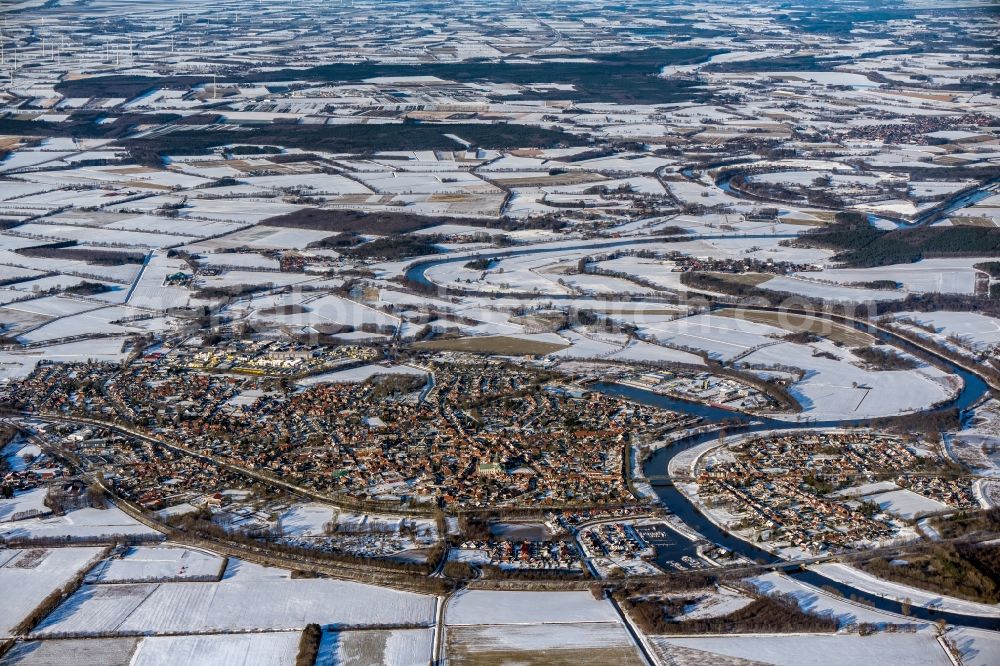 Haren (Ems) from the bird's eye view: Wintry snowy urban area with outskirts and inner city area on the edge of agricultural fields and arable land in Haren (Ems) in the state Lower Saxony, Germany