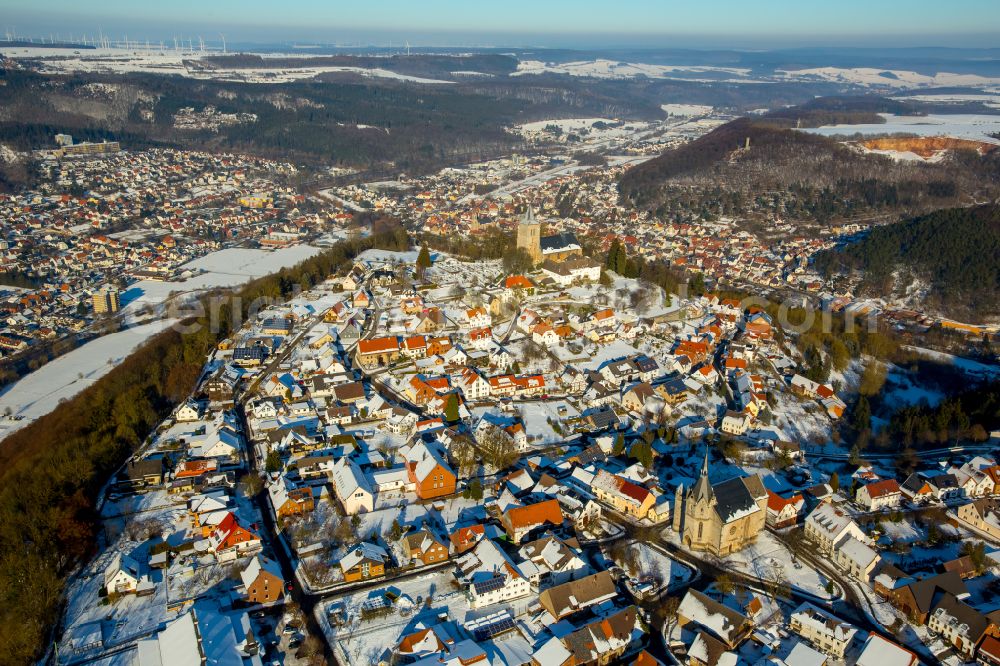 Marsberg from the bird's eye view: Wintry snowy urban area with outskirts and inner city area on the edge of agricultural fields and arable land in Marsberg at Sauerland in the state North Rhine-Westphalia, Germany