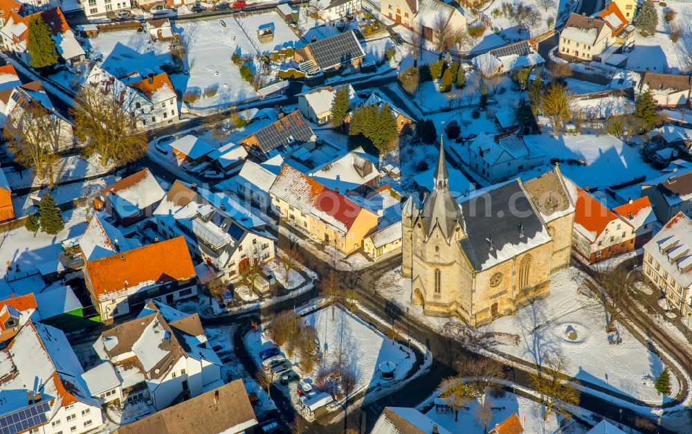 Aerial image Marsberg - Wintry snowy urban area with outskirts and inner city area on the edge of agricultural fields and arable land in Marsberg at Sauerland in the state North Rhine-Westphalia, Germany