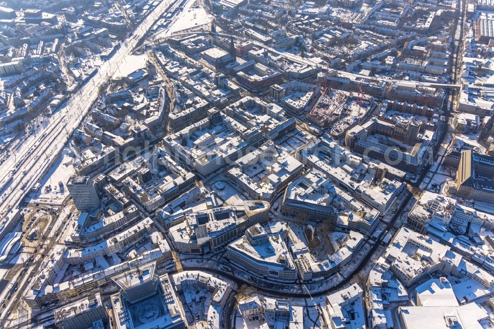 Bochum from the bird's eye view: Wintry snowy the city center in the downtown area with an ensemble of shopping centers and a residential and commercial district on Massenbergstrasse - Bongardstrasse - Kortumstrasse - Huestrasse in the district Innenstadt in Bochum at Ruhrgebiet in the state North Rhine-Westphalia, Germany